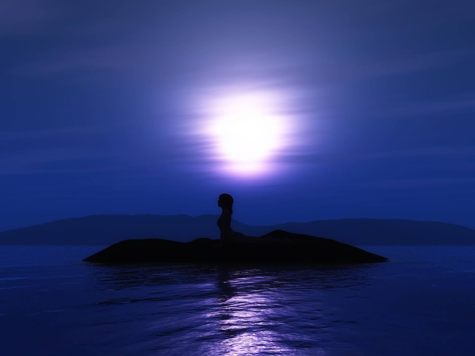 Person meditating under moonlight representing solitude, retreat and spiritual surrender.