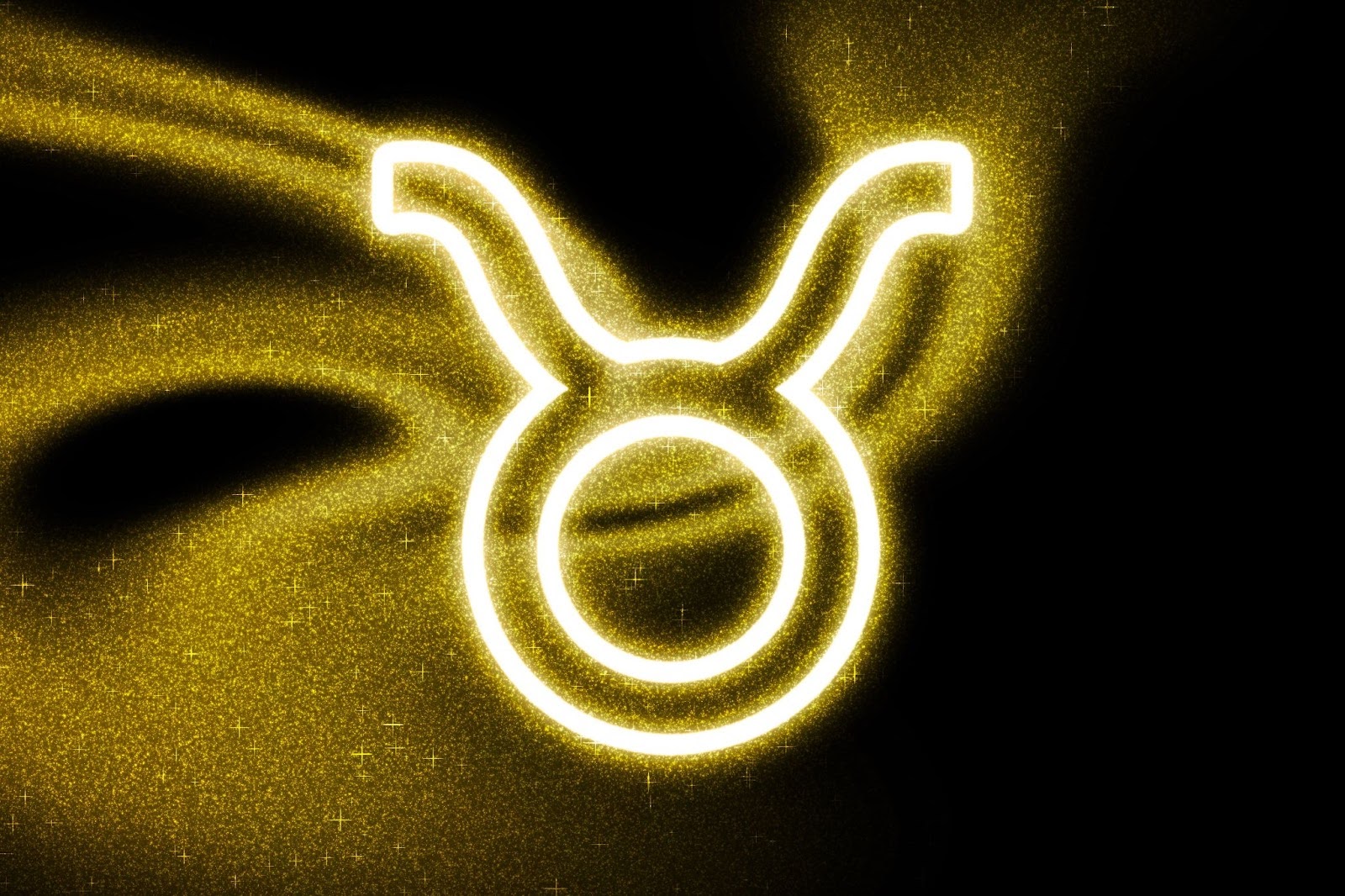 Golden Taurus zodiac symbol glowing on a dark cosmic background, representing Taurus traits, stability, and luxury in love and Valentine’s Day astrology.