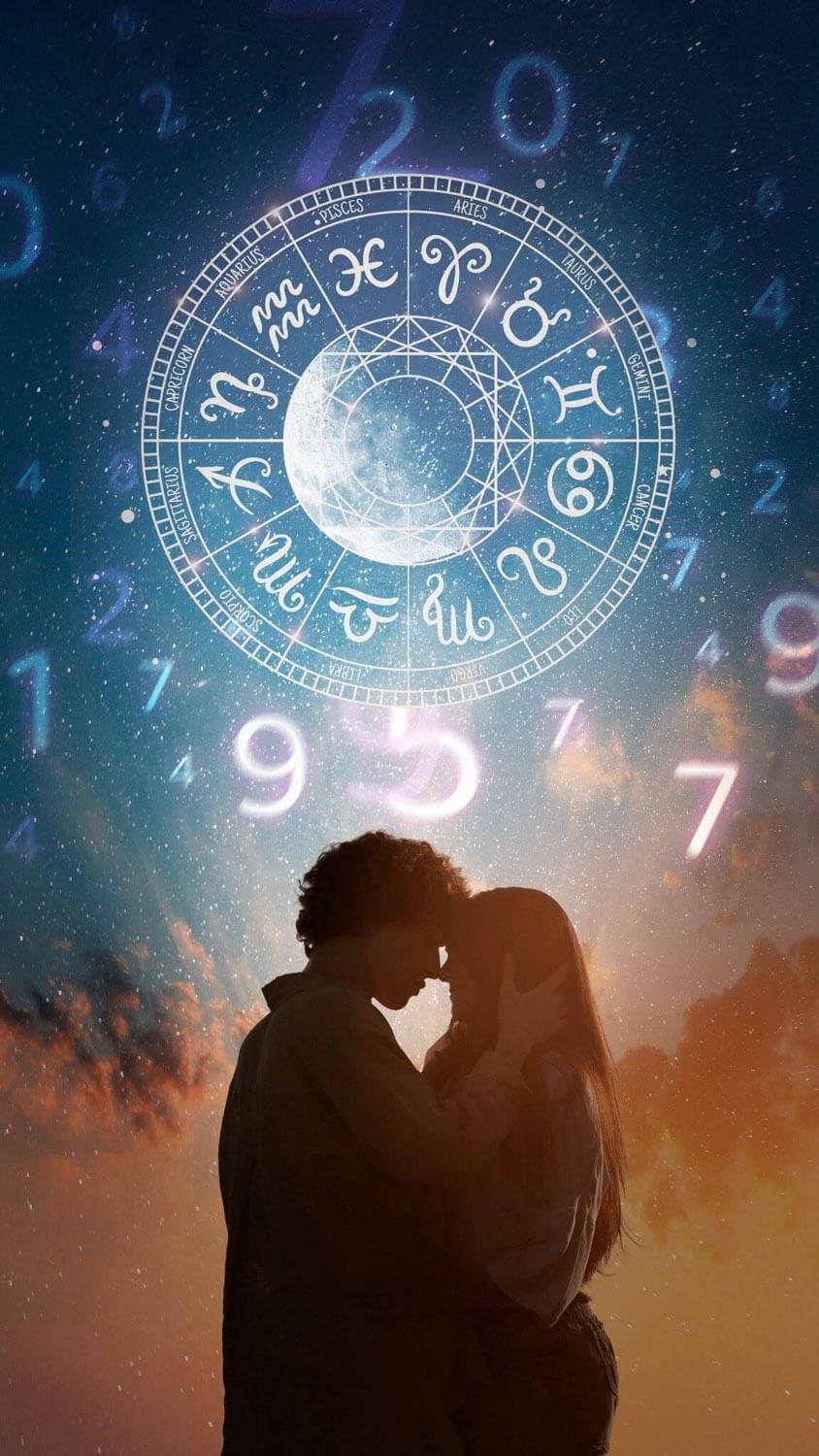 Romantic couple beneath a glowing zodiac wheel representing zodiac crush signs and astrology compatibility in love.