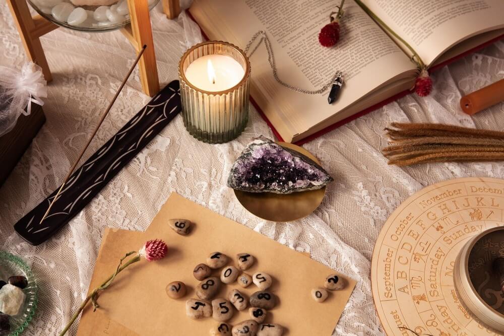 Spiritual numerology setup with candle, crystals, and astrology tools representing reflection during Mercury Retrograde July 2026.